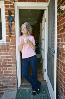 Caucasian woman drinking cup of coffee in doorway