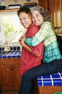 Smiling couple hugging in kitchen