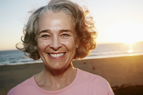 Caucasian woman smiling at beach