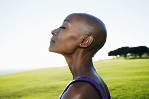 Profile of African American woman smiling in park