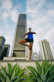 African American woman practicing yoga on urban rooftop