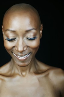 Close up of smiling face African American woman looking down