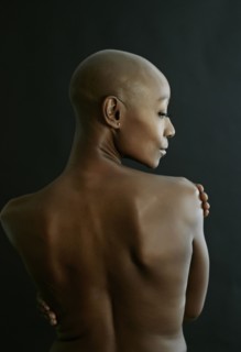 Nude African American woman looking over her shoulder