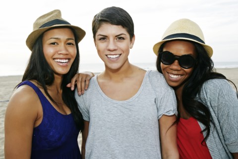 Close up of women smiling on beach