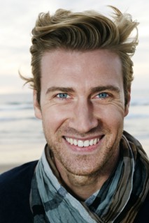 Caucasian man smiling on beach