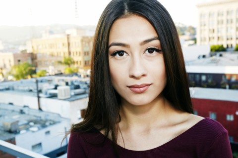 Mixed race woman standing on urban rooftop