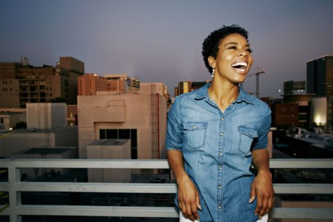 Woman laughing on urban rooftop