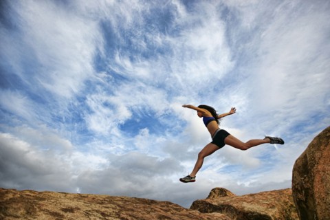 Vietnamese woman running in rocky field