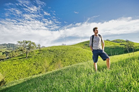 Caucasian man standing on rural hilltop