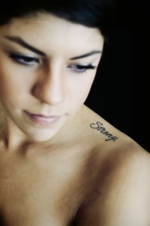 Hispanic woman with strong tattoo on shoulder