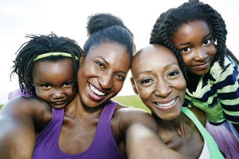 Women and children smiling outdoors