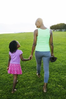 Mother and daughter holding hands in park
