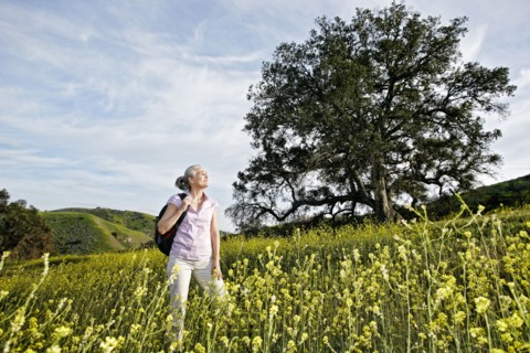 Caucasian woman standing in tall grass