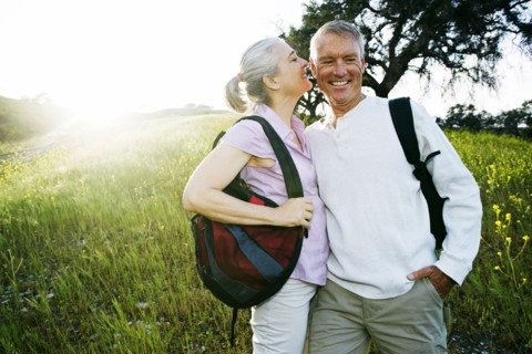 Caucasian couple kissing in tall grass