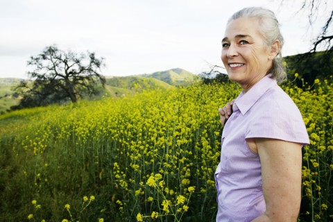 Caucasian woman standing in tall grass