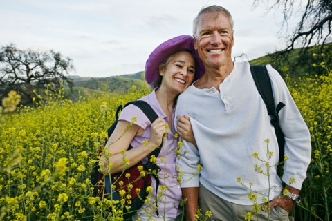 Caucasian couple standing in tall grass