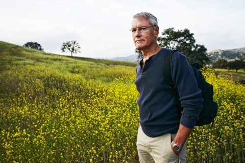 Caucasian man standing in tall grass