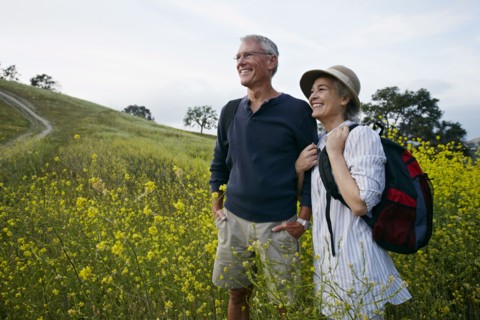 Caucasian couple standing in tall grass