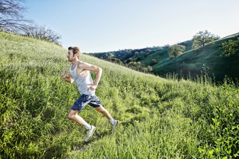 Caucasian athlete running on rural trail