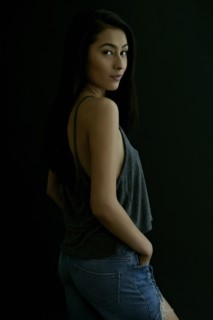 Hispanic woman looking over shoulder