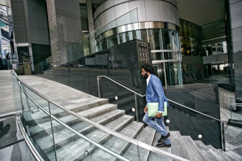 Mixed race businessman carrying digital tablet
