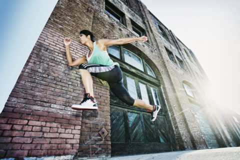 Mixed race woman jogging on sidewalk