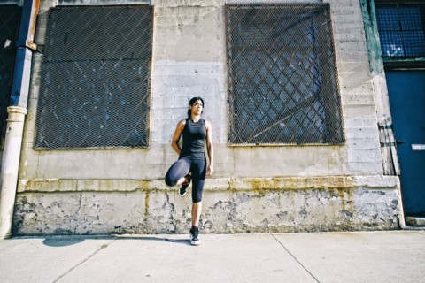 Mixed race woman leaning on wall