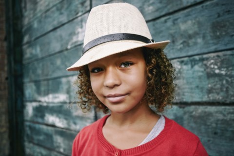 Mixed race girl wearing fedora