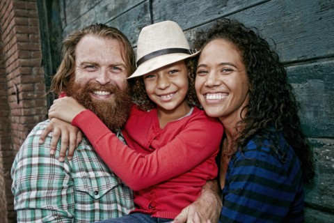 Family hugging outdoors