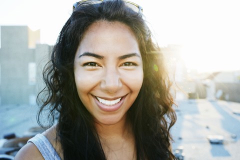 Hispanic woman smiling outdoors