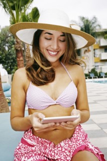 Hispanic woman using digital tablet outdoors
