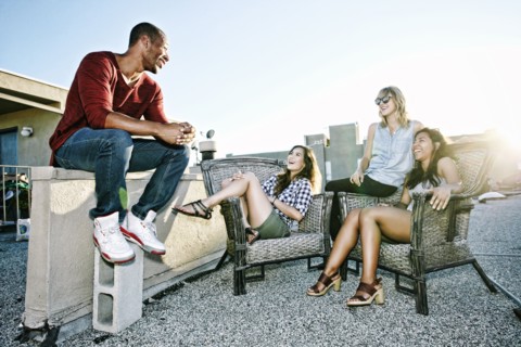 Friends relaxing on urban rooftop