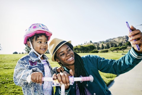 Black mother and daughter taking selfie