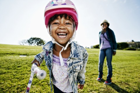 Black mother and daughter playing in park
