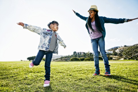 Black mother and daughter playing in park