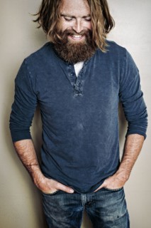 Caucasian man standing with hands in pockets