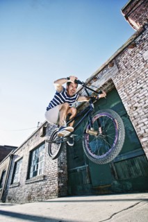 Caucasian man jumping on BMX bike
