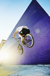Caucasian man jumping on BMX bike