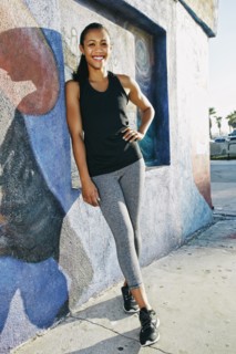 Mixed race athlete leaning on mural wall