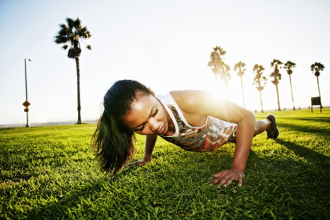 Mixed race athlete doing push-ups in park