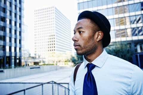 Black businessman standing outside office building