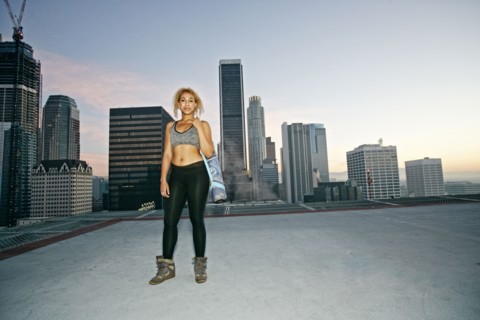 Mixed race woman standing on urban rooftop