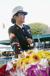 Asian soldier shopping in flower market