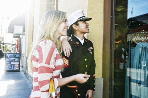 Asian soldier and friend window shopping