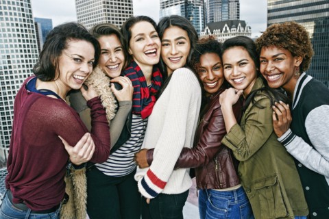 Stylish women posing on urban rooftop