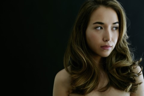 Portrait of serious naked Hispanic woman