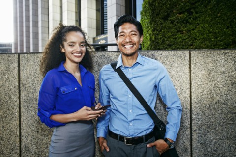 Smiling businesspeople posing outdoors