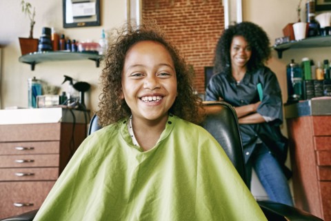 Smiling hairdresser and customer in hair salon