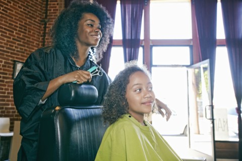 Smiling hairdresser and customer in hair salon
