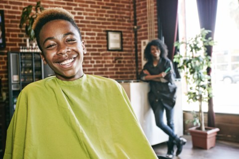 Smiling hairdresser and customer in hair salon